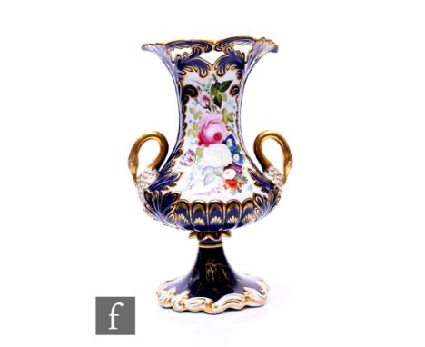 An early 19th Century Staffordshire footed vase, in the manner of Coalport, of compressed baluster form, gilded swan neck han