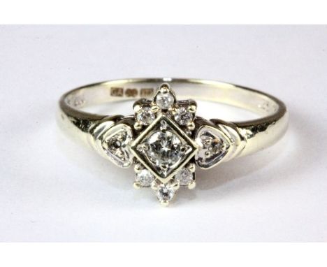 A 9ct white gold diamond cluster ring, (S.5).