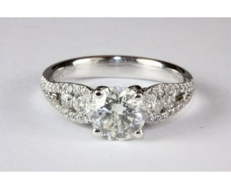 A very pretty 18ct white gold ring set with a centre diamond (approx. 1.17ct) with diamond mounted shoulders (approx. 0.45ct)