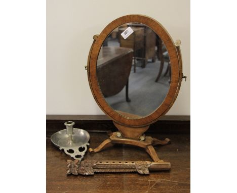 A dressing table mirror, a pewter chamber stick and a rosewood flute.