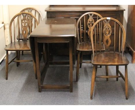An Ercol beech wood drop leaf cottage dining suite together with an Ercol dresser.