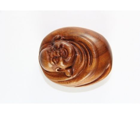 A carved hardwood netsuke of the Happy Buddha, L. 6cm.