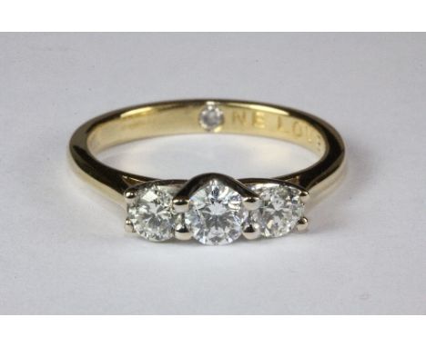 An 18ct yellow gold ring set with three good quality brilliant cut diamonds (Total weight approx. 0.85 ct) (M).