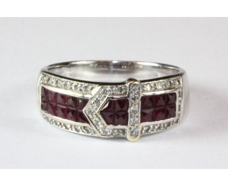 An 18ct white gold ruby and diamond set buckle ring (N.5).