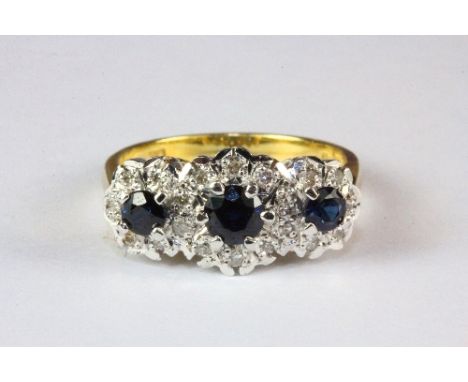 An 18ct yellow and white gold sapphire and diamond triple cluster ring, (P).