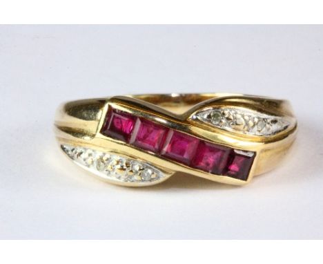 A 9ct gold ruby and diamond crossover ring (M).