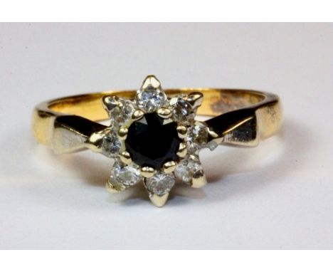 An 18ct yellow gold (Tested and with worn hallmark), sapphire and diamond cluster ring, (L.5).