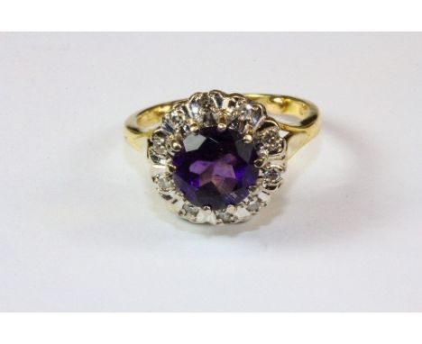 An 18ct yellow gold amethyst and diamond cluster ring (O).