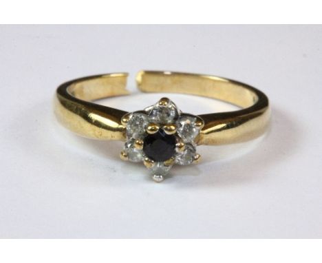 A 9ct yellow gold diamond and sapphire daisy cluster ring, (split shank) (P.5).