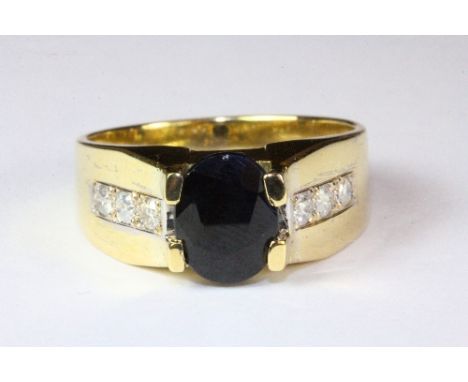 A gents 18ct yellow gold ring set with a large sapphire and diamond set shoulders, (V).