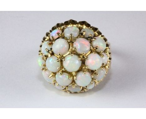 A large 14ct yellow gold domed opal cluster ring, (U).