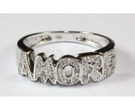 A 9ct white gold and diamond set AMORE ring, (M).