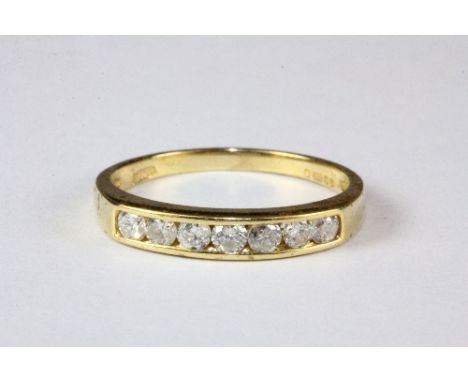 An 18ct yellow gold 7 stone diamond ring, (M).