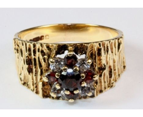 A 9ct gold, garnet and diamond cluster ring (O).