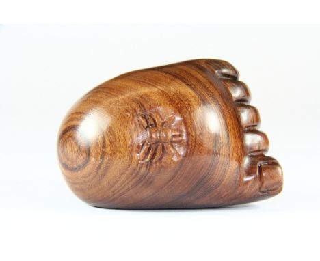 A Chinese carved hardwood netsuke of the Buddha's foot with a spider, L. 7cm.