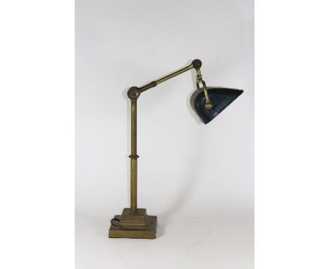 A 1930s heavy brass angle poise desk lamp with an enamelled metal shade, H. 48cm (to hinge).