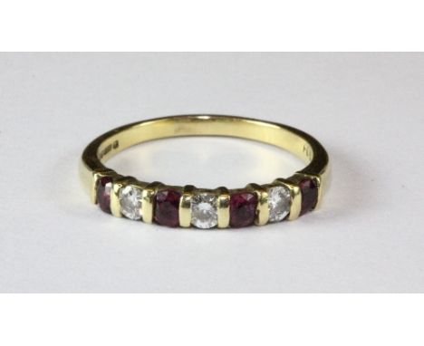 An 18ct gold ruby and diamond half eternity ring (M).