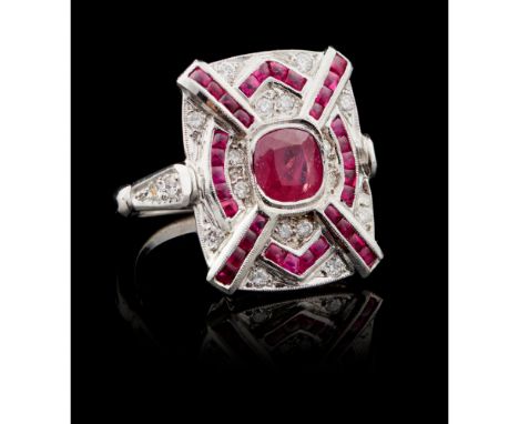 A ring Gold 800/000Set with cabochon cut calibrated rubies, one round cut ruby of approximately 1 ct., and twenty brilliant c