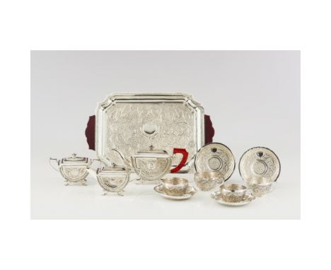 Tea set In silverComposed of: tray, teapot, sugar bowl, milk jug, four saucers, and four cupsProfuse decoration in the Orient