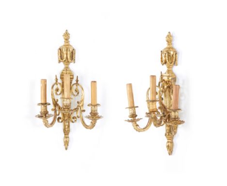 A pair of Louis XVI-style three-light wall sconces In gilded bronzeWith raised decorationFrance, 19th century(Small defects a