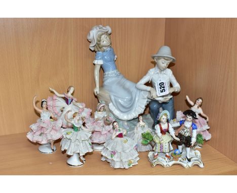 A GROUP OF CERAMIC FIGURINES, to include a Nao by Lladro Tender Moment figurine of a boy bandaging a girl's foot, by Jose Roi