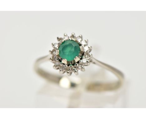 A GREEN CHALCEDONY AND DIAMOND CLUSTER RING, the central circular green chalcedony within a single cut diamond surround, stam