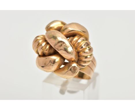 A GENTLEMEN'S YELLOW METAL RING, of a large knot design, leading onto a textured band, stamped '750', ring size R, approximat
