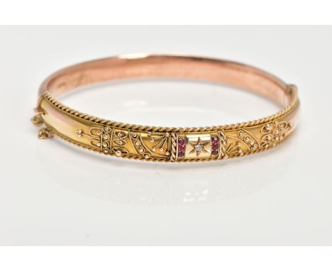 AN EARLY 20TH CENTURY GOLD BANGLE, a 9ct gold hollow hinged bangle, set with a single rose cut diamond in a star setting and 