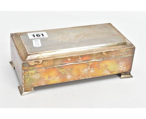 A SILVER LINED CIGARETTE BOX, of a rectangular form, engine turned design with a floral engraved cartouche to the lid, raised