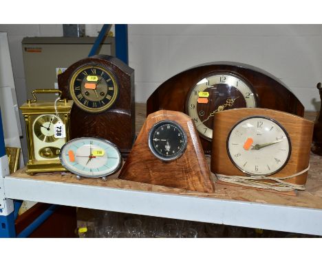 SIX WOODEN AND METAL CASED MANTEL AND ALARM CLOCKS, including a Smiths black dial car clock mounted in a later walnut frame, 