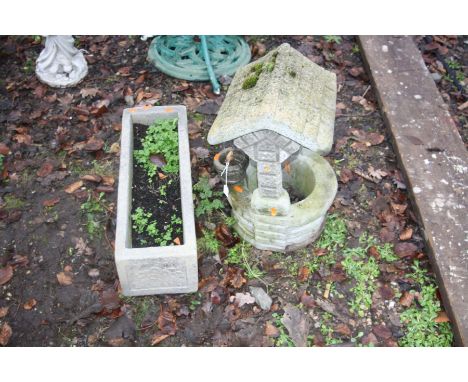 A SMALL COMPOSITE GARDEN WELL ORNAMENT AND A RECTANGULAR PLANTER 62cm long