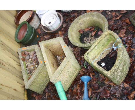 FOUR MODERN COMPOSITE GARDEN PLANTERS including a pair of trapezoidal planters 53cm long, a round and a quadrant shaped plant