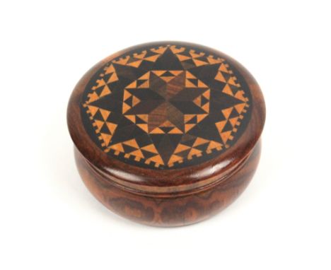 A well turned rosewood circular Tunbridge ware box,  the over hanging lid in geometric stickware, 6cm dia