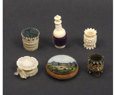 Five pin cushions and emeries  comprises a reverse glass decorated disc form example titled 'International Exhibition 1862', 