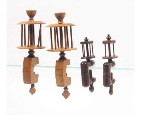 Two pairs of clamps comprising a rosewood pair with ring turned rectangular frames below reel tops, 15.5cm, and a whitewood p