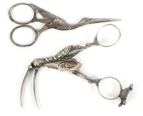 A pair of 19th Century German (Augsburgh) silver ribbon scissors in the form of a stork opening to reveal a swaddled baby, on
