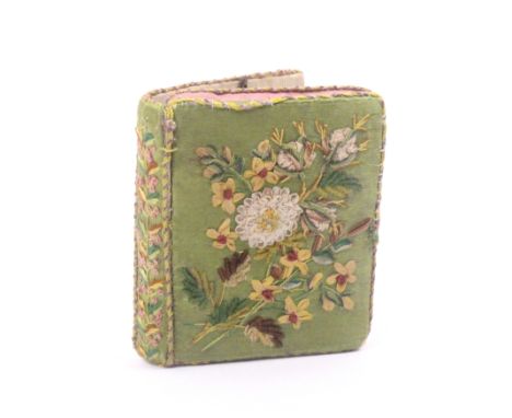 A fine Georgian needlework sewing companion in the form of a book in green silk, the covers and spine in raised floral silk, 