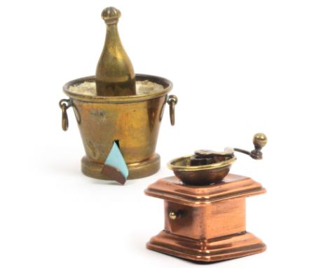 Two novelty tape measures comprising a brass example in the form of a bottle in ice bucket, tape replaced, 5.5cm, and another