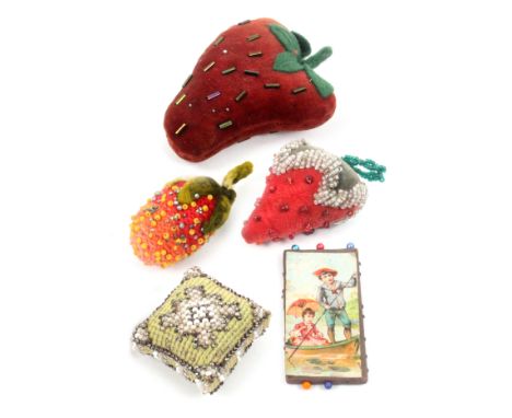 Five pin cushions and emeries comprising three strawberry format examples, largest, 10cm, a wool and beadwork cushion example