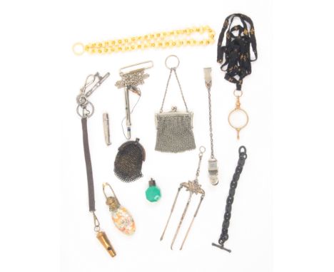 A mixed lot comprising a glass scent bottle with gilt hinged cover, on chains, 10cm, two small chain mesh purses, a whistle a