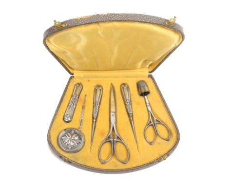 An early 20th Century continental sewing companion the case with curved front and covered in grey paper, the yellow silk and 