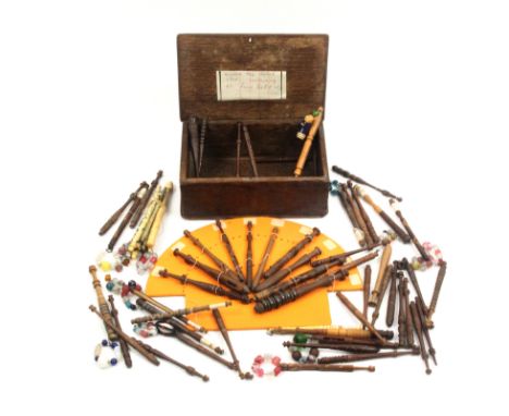 A lace bobbin box and a selection of lace bobbins, the rectangular oak box pin initialled and dated 1805, the bobbins compris