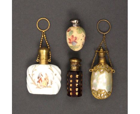 Four late 19th Century/early 20th Century scent bottles, comprising a ruby glass example of octagonal section with gilded cir