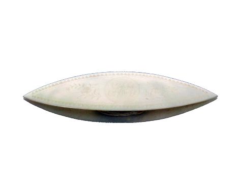 A Chinese mother of pearl engraved shuttle  initialled 'MC' within flower sprays within a scroll and dog tooth border to both