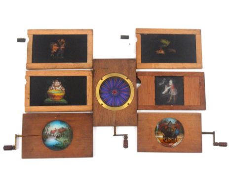 Seven mechanical magic lantern slides in wooden frames comprising three rotating circular slides - knife grinder/spiral/ wate
