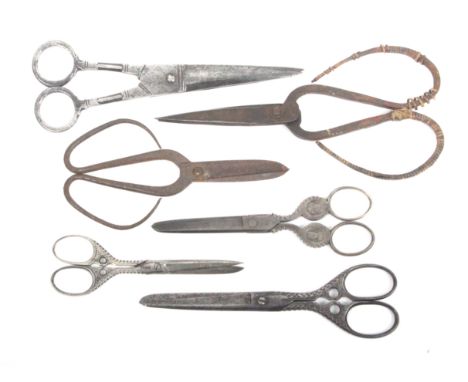 Six pairs of larger format steel scissors comprising a pair of 18th century probably Turkish scissors with hollow ground blad