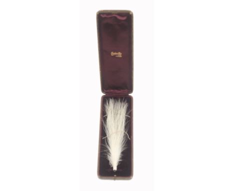 An Edwardian leather cased hair ornament, the rectangular red leather case velvet and silk lined and named for 'Gowland Bros'