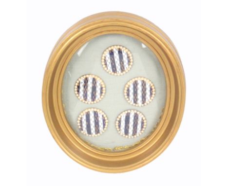 Buttons - a framed set of five 18th Century enamel buttons, probably French, in alternate stripes of blue and white enamel ea