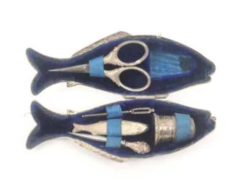 A silver plated etui in the form of a fish with a full complement of fittings, ring suspension to mouth, the blue velvet inte