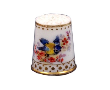 A late 19th Century porcelain thimble, Worcester, well painted with a bird on a flowering branch and a branch of flowers with